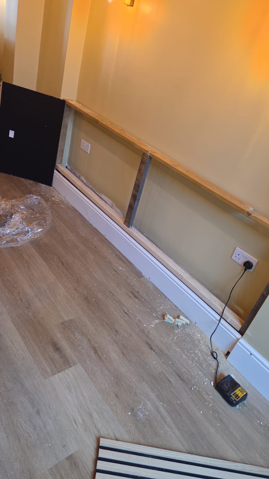 Carpentry team fitting custom wall trim layout accurately